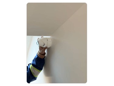 a man is holding a security camera