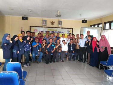 a group of people standing in front of a classroom