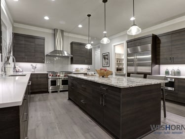 Sleek kitchen featuring dark wood cabinets and stainless steel appliances.