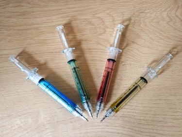 Pens in shape of syringes
