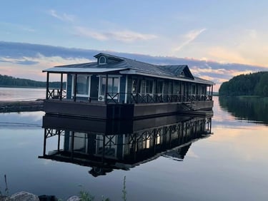a houseboater is sitting on a dock with a view of the water