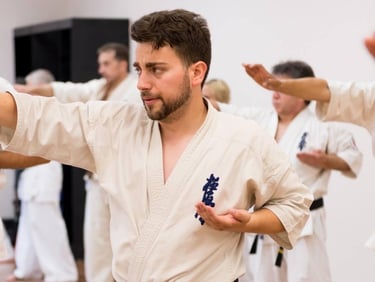 a man in a karate uniform is doing karate moves