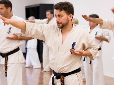 a man in a karate uniform is doing karate moves