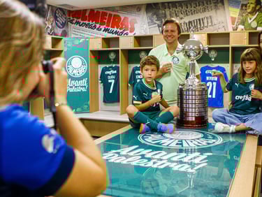 a man and woman in a locker room with a trophy