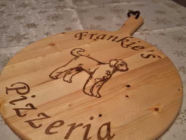 a wooden pizza board with a dog on it