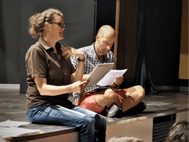 Teachers Harriet Thompson and Schuyler Hedstrom teaching a theatre class on a stage in Madrid