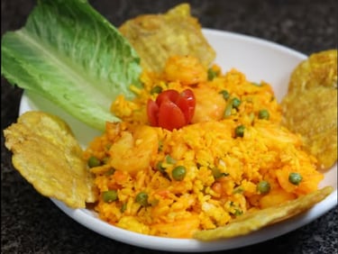 a plate of shrimp with rice and tostones