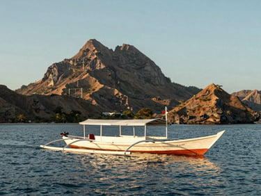A luxury traditional phinisi boat sailing through the pristine waters of Komodo National Park, dramatic volcanic islands in the background, warm daylight