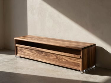 Wide shot of a minimalist entryway with a walnut flip-top bench. The top is slightly propped open, showing a glimpse of structured storage. High-contrast shadows on a warm plaster wall.