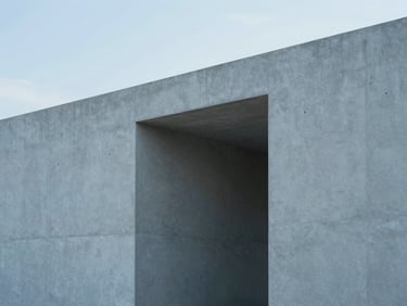 Minimalist concrete architectural structure with clean lines and geometric shadows in cool diffused daylight