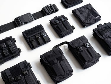 Organized flat lay of tactical service gear, utility belts, and durable pouches on a clean white surface, bright daylight