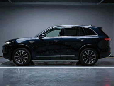 Sleek, unmarked black executive SUV parked in a secure, modern facility, soft cool light reflecting off its polished surface, wide environmental shot, 35mm.