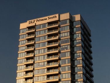 Golden hour architectural shot of DLF Privana South facade, modern high-rise glass balconies, deep navy sky, 35mm