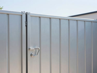 Sharp medium shot of a modern sleek aluminum sliding gate, crisp natural daylight, clean metallic details