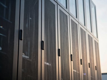 Macro detail of modern concrete and glass server facility facade, architectural lines reflecting cool morning light, structured composition.