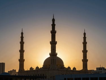 Wide panoramic cityscape of Madinah Nabawi Mosque minarets at sunset, golden glowing sky, majestic architectural silhouette, elegant luxury travel feel, no people.