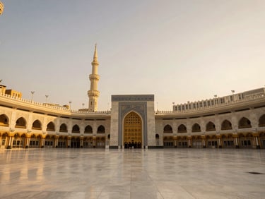 Symmetrical majestic wide shot of the grand architectural details of the Holy Mosque in Makkah, golden hour warm light, serene atmosphere, pristine marble, no people, architectural luxury editorial photography.