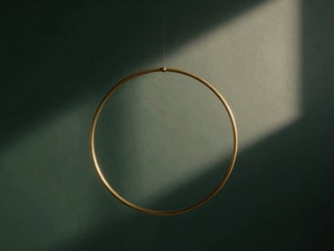 Abstract geometric representation of mathematical balance, intersecting brass rings, soft diffused light, deep rich shadows, 35mm