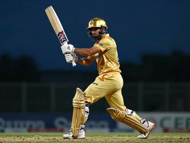 Low-angle action shot of a cricket batsman swinging, golden stadium light reflecting off the helmet, dark blue background.