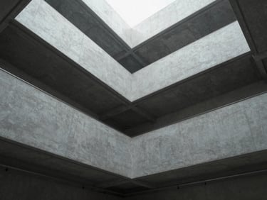Wide angle architectural perspective looking upward at a minimalist concrete and steel atrium, clean geometric shadows, diffused cool neutral light