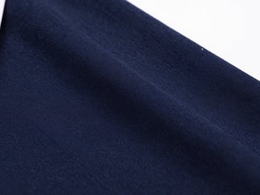 Macro shot of tightly woven navy blue school uniform fabric, showing individual threads and texture, under clean studio light.