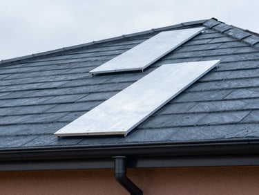 Close-up of clean, hand-shaped zinc panels and gutters on a modern residential roofline, soft daylight, industrial craftsmanship