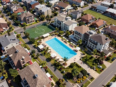 A dramatic drone shot of a luxury residential township with a massive swimming pool and sports amenities, bright daylight