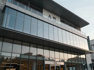 Modern commercial retail mall facade with glass panels and structured corporate design, daytime