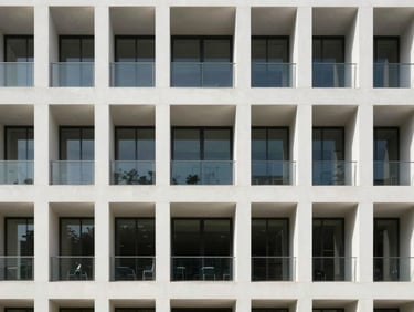 Crisp architectural photography of a modern minimalist office building facade in Tuxpan, bright natural daylight, clean geometric lines, sharp focus, 35mm