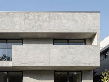 Crisp architectural elevation of a modern minimalist concrete house, natural daylight, sharp focus, 35mm