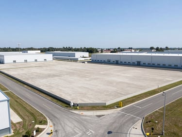 Crisp architectural photography of clean industrial land plot with access roads, bright daylight, 35mm