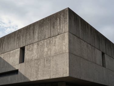 Brutalist concrete building facade in Paris, high contrast shadows, overcast sky, 16:9 aspect ratio.