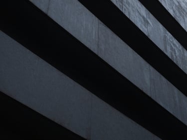 Abstract architectural geometry, low-key dramatic chiaroscuro, cool-toned ambient light with sharp high-contrast highlights, minimalist fine art photography, 35mm lens