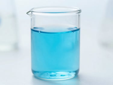 Macro clean clinical photography of high-tech laboratory glass with glowing blue biological fluid, bright natural light, shallow depth of field, 35mm