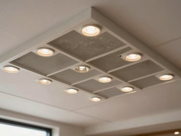 Close-up overhead study of a suspended ceiling grid in a commercial restaurant space with newly installed recessed LED luminaires, each fixture aligned precisely in the grid, clean white ceiling tiles, warm-neutral lamp color under north-facing natural daylight, no workers visible, no text or signage, studio-quality even lighting showing fixture detail and installation precision