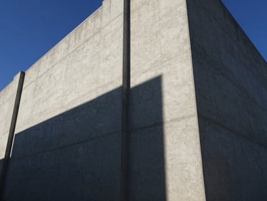 Low-angle heroic shot of a massive poured concrete commercial facade under harsh afternoon sunlight, casting deep geometric shadows, sharp architectural lines.
