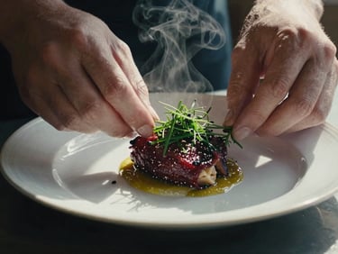 Close-up of a plated artisanal dish, steam rising, hands of a chef garnishing with herbs, soft Scandinavian daylight, moody shadows, 35mm