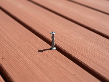 Close-up of clean cedar deck boards being secured with deck screws, bright outdoor sunlight, sharp editorial photography, 35mm
