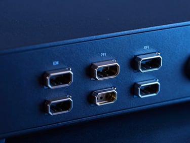 Detailed close-up of pristine HDMI and optical ports on the side of a modern television panel, cool technical studio lighting