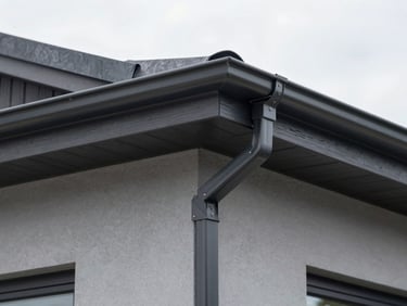 Tight detail shot of perfect dark aluminum gutter joints and fascia boards on a modern home