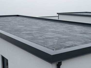 Clean, modern torch-on flat roofing system on a commercial building, showing immaculate seams.