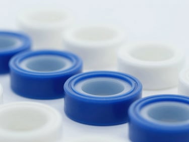 Macro shot of custom-vulcanized elastomeric seals, sterile laboratory lighting, cool tones