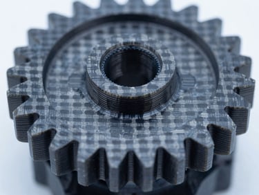 Macro close-up shot of a 3D printed carbon-fiber mechanical gear, high-contrast technical studio lighting, cool blue tones, sharp details of layers.