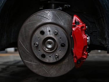 Macro shot of a clean, heavy-duty brake disc and caliper, dark metallic background, dramatic low-key lighting, industrial automotive photography.