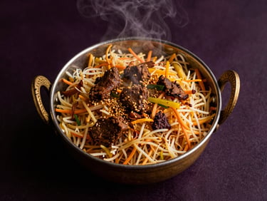 Overhead flat-lay of heritage-grade Biryani served in a heavy brass pot, rising steam, warm golden highlights, dark background