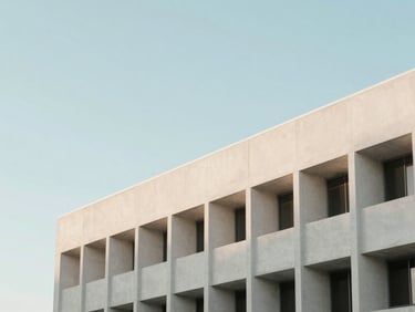 Abstract architectural lines of a modern concrete building in Orlando against a pale blue sky, soft morning daylight, minimalist composition