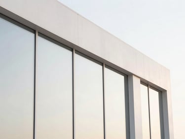 Close-up of clean architectural glass reflecting soft pastel morning light, high-key lighting, minimalist aesthetic