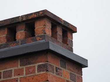 Close-up of a newly repaired chimney crown, showing smooth, waterproof concrete, overcast daylight.