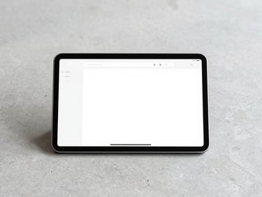 Clean screenshot of a minimalist digital dashboard on a physical tablet device resting on a light grey concrete desk, soft shadows