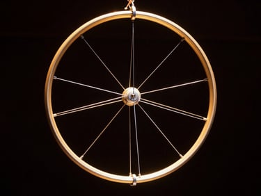 Technical diagram aesthetic of a circular Cyr wheel and aerial hoop rigging points, clean lines, high-contrast gold and white on dark background